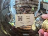 a person holding a glass ball with a gold coin inside of it