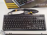a keyboard and mouse sitting on a table next to a box