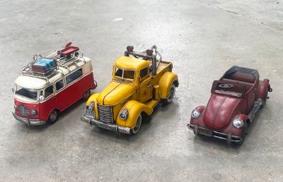 three toy cars that are sitting next to each other