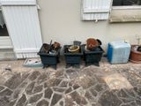 several pots and pans are lined up on the side of a house