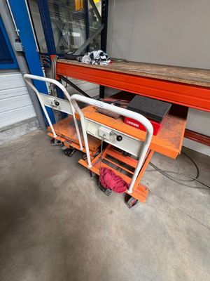 a cart with a table and a chair in the garage