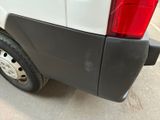 the rear end of a white truck with a flat tire