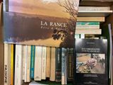 many books that are on a shelf in a box