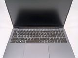 a silver laptop with a black keyboard on a white surface