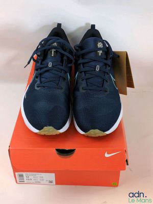 a pair of nike shoes in a box on a white background