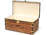 a brown and white suitcase that is open on a white surface