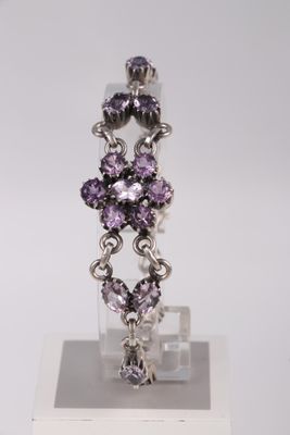 a close up of a pair of earrings on a display stand