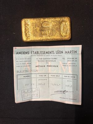 an image of a piece of gold sitting on top of a black table