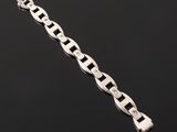 a silver bracelet on a black background