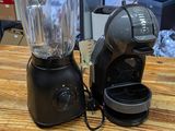a blender and a coffee maker sitting on a table
