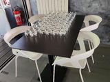 a black table with white chairs and a black table with white chairs and a black table with white chairs and a black table with white chairs and a black