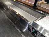 an empty conveyor belt in a commercial kitchen