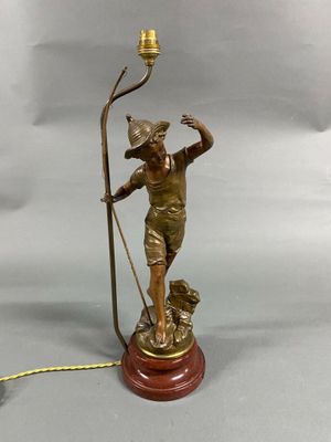 an antique bronze figurine of a man with a staff and a dog