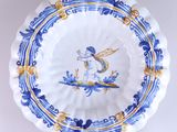 a blue and yellow plate with a dragon on it