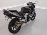 a black motorcycle parked in a room with a white floor