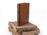 books stacked on top of each other on a white surface