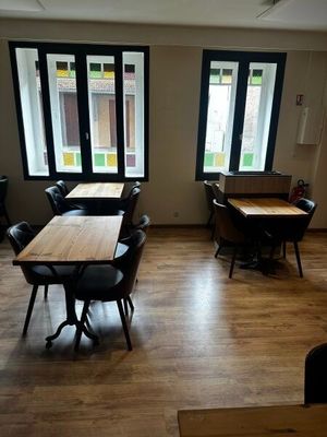une pièce équipée de tables et de chaises et dotée de fenêtres