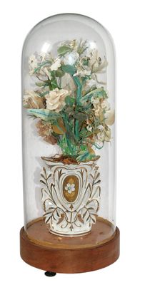 a glass dome with flowers inside of it on a wooden stand