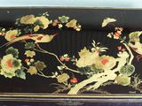 a black box with birds and flowers painted on it