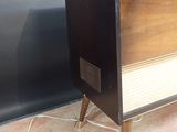 an old fashioned television sitting on top of a wooden stand