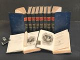 several old books sitting on top of a table next to each other