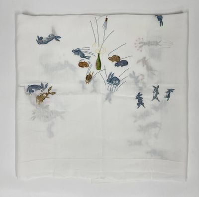 une image représentant un mouchoir blanc orné d'oiseaux bleus