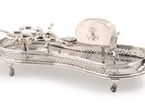 a silver tray with a clock on top of it