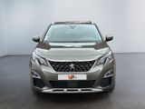 the front view of a grey car in a white room