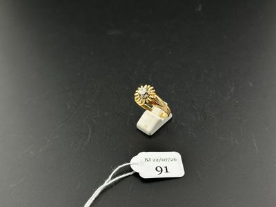 a close up of a tag on a table with a ring on it