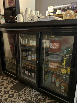 a refrigerator with a lot of drinks inside of it