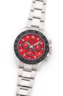 an image of a wrist watch with a red face and black bezel