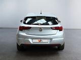 a silver car parked in a room with a white wall