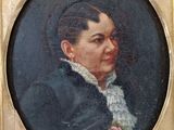 portrait of a woman in a black coat with a rose in her hair