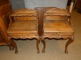 two wooden chairs sitting next to each other on a carpeted floor
