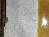 a picture of a yellow and white plate sitting on a table