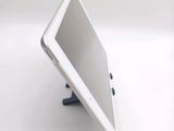 a tablet computer sitting on a stand on a white surface