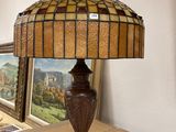 a lamp that is sitting on a table next to a picture