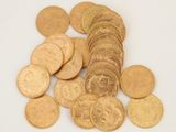 a pile of gold coins on a white surface