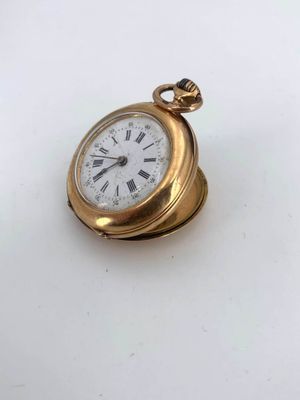an image of a gold pocket watch with roman numerals on the face