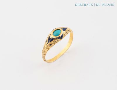 a close up of a gold ring with a turquoise stone