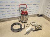 a vacuum that is sitting on the floor next to some hoses