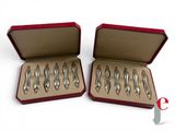 six silver spoons in a red box on a white surface