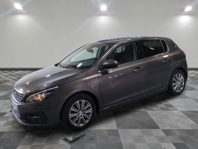 the grey car is parked in the garage on a checkered floor