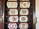 many plates on a shelf in a cabinet