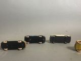 three black and gold cuff bracelets with a gold clasp