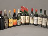 several bottles of wine are lined up on a gray surface