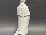 statue of a woman in a white dress with a hat on her head