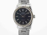 an image of a wrist watch with a black dial on a silver bracelet