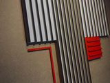 a picture of a wall with a cross made of metal bars