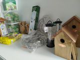 many different birdhouses on a white shelf in a room